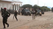 SOMALIA-CONFLICT/ Somali government soldiers run to position during an ambush by al Shabaab rebels on the outskirts of Elasha town