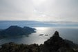 Fra toppen, utsikt mot sørvest. Aasand sanden midt i bildet, Bøs høyeste topp Burnestinden 693moh, og Lofotveggen langt der bak skimtes.
