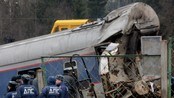  Police officers stand guard at the site of a train derailment near the village of Uglovka, about 40