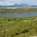 Oversiktsbilde fra Middagsfjellet som viser Hovedhuset og Kårstua, Straumøya og Landegode i bakgrunnen.