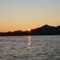 Novembersola i ferd med å forsvinne over Balsfjord i Troms.