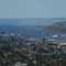 Hurtigruta blir hyllet ved ankomst Bodø mens et cruisskip sniker seg ubemerket forbi utenfor Hjartøya. Bildet er tatt fra Junkerfjellet.