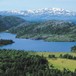 Oversikt over Mostølområdet. Hytta ligger på den grønne stølsvollen i forgrunnen. Bak ligger Mostølvatnet