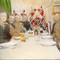 Festmiddag i Framheims stue. Rundt bordet sitter Olav Bjaaland, Sverre hassel, Oscar Wisting, Helmer Hanssen, Roald Amundsen, Hjalmar Johansen, Jørgen Stubberud og Kristian Prestrud. Hvalbukta, Antarktis, 1911. Kolorert glassdias.