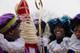 AP -FILE- In this Saturday Nov. 16, 2013, image The Dutch version of Santa Claus, Sinterklaas, or Saint Nicholas, and his blackface sidekicks "Zwarte Piet" or "Black Pete" arrive by steamboat in Hoorn, north-western Netherlands. Saint Nicholas is due to arrive in the Netherlands Saturday Nov. 16, 2019, in an annual children's party that has become the backdrop for increasingly acrimonious confrontations between supporters and opponents of his sidekick, Black Pete, a depictions which opponents say promotes racist stereotypes. (AP Photo/Peter Dejong, File)