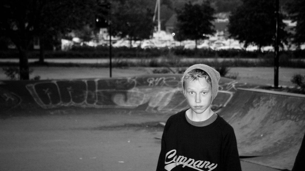 En ung Einar Aandrésen ser i kameraet foran en skatebowl. Det er seilbåter i bakgrunnen.