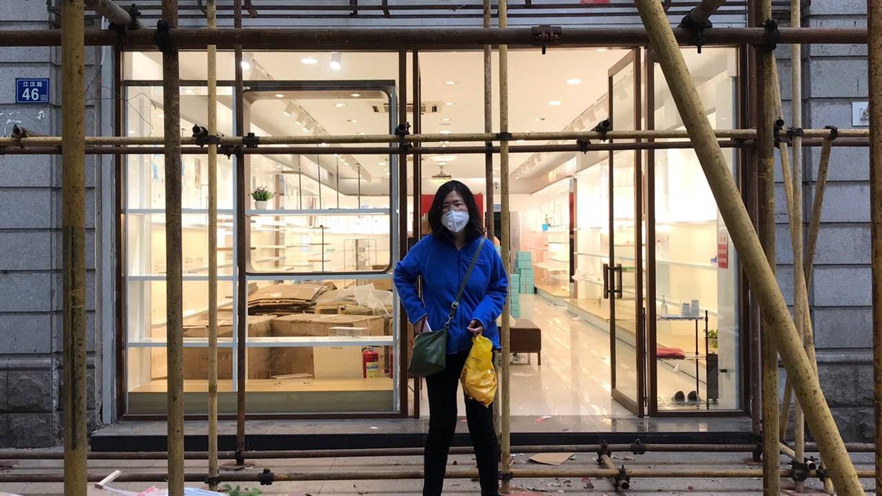 Zhang Zhan stands in front of a store in Wuhan on April 11. 