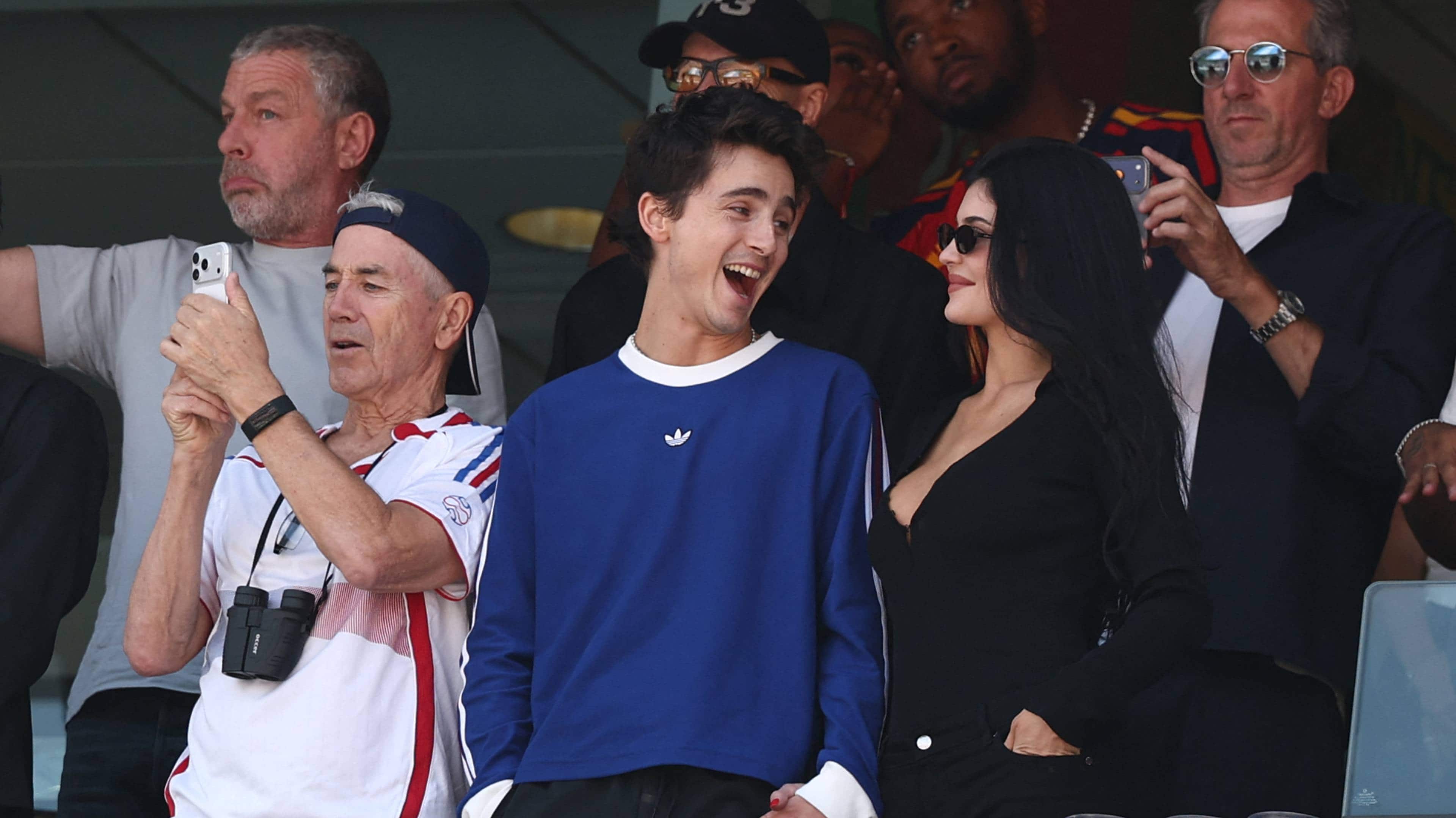 Timothee Chalamet (C), US Media personality Kylie Jenner (R), and Marc Chalamet (L) attend the 2026 World Cup football tournament final match between Spain and Argentina at the New York/New Jersey Stadium.