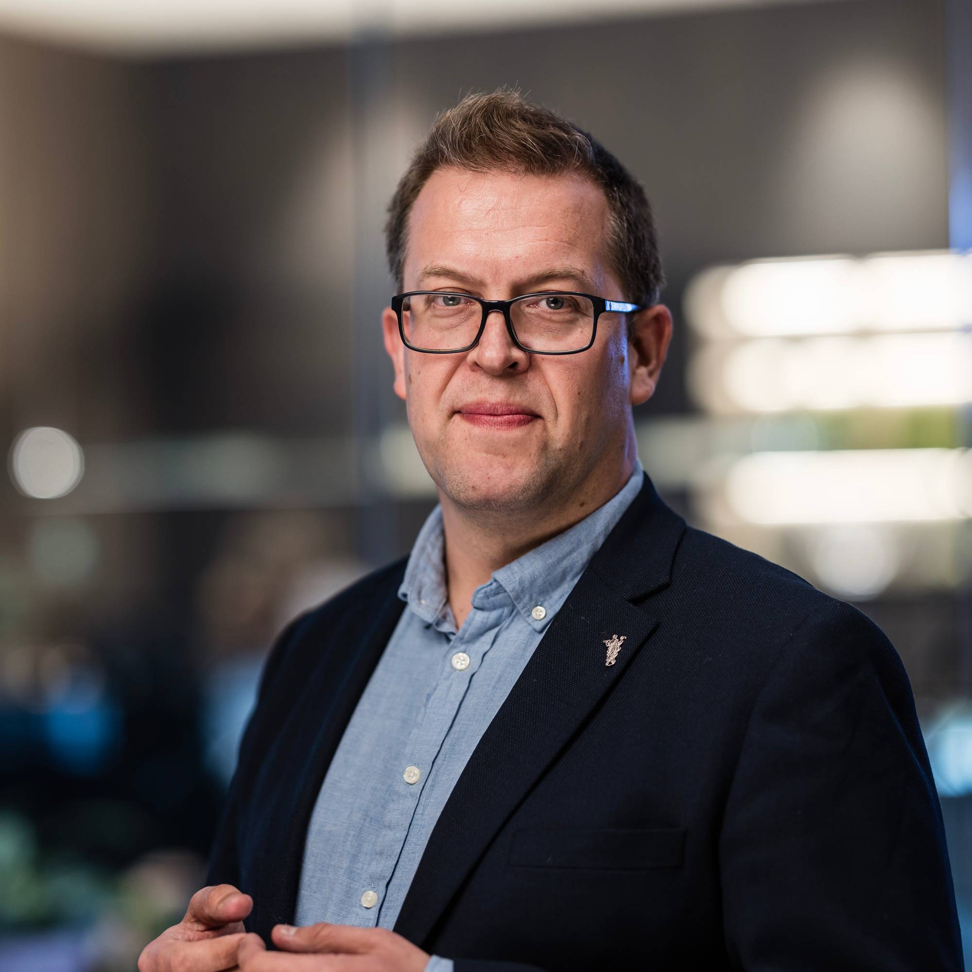 Mann med briller ser inn i kamera 