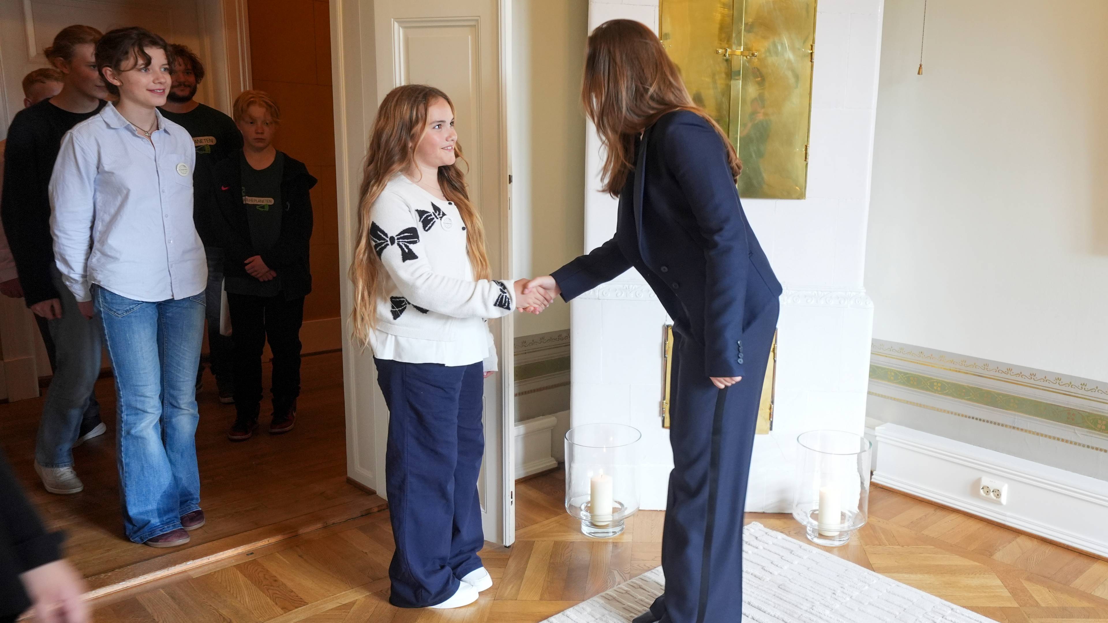 Prinsesse Ingrid Alexandra står på kontoret sitt på Slottet og hilser på Barnas Klimapanel som kommer i audiens hos henne.