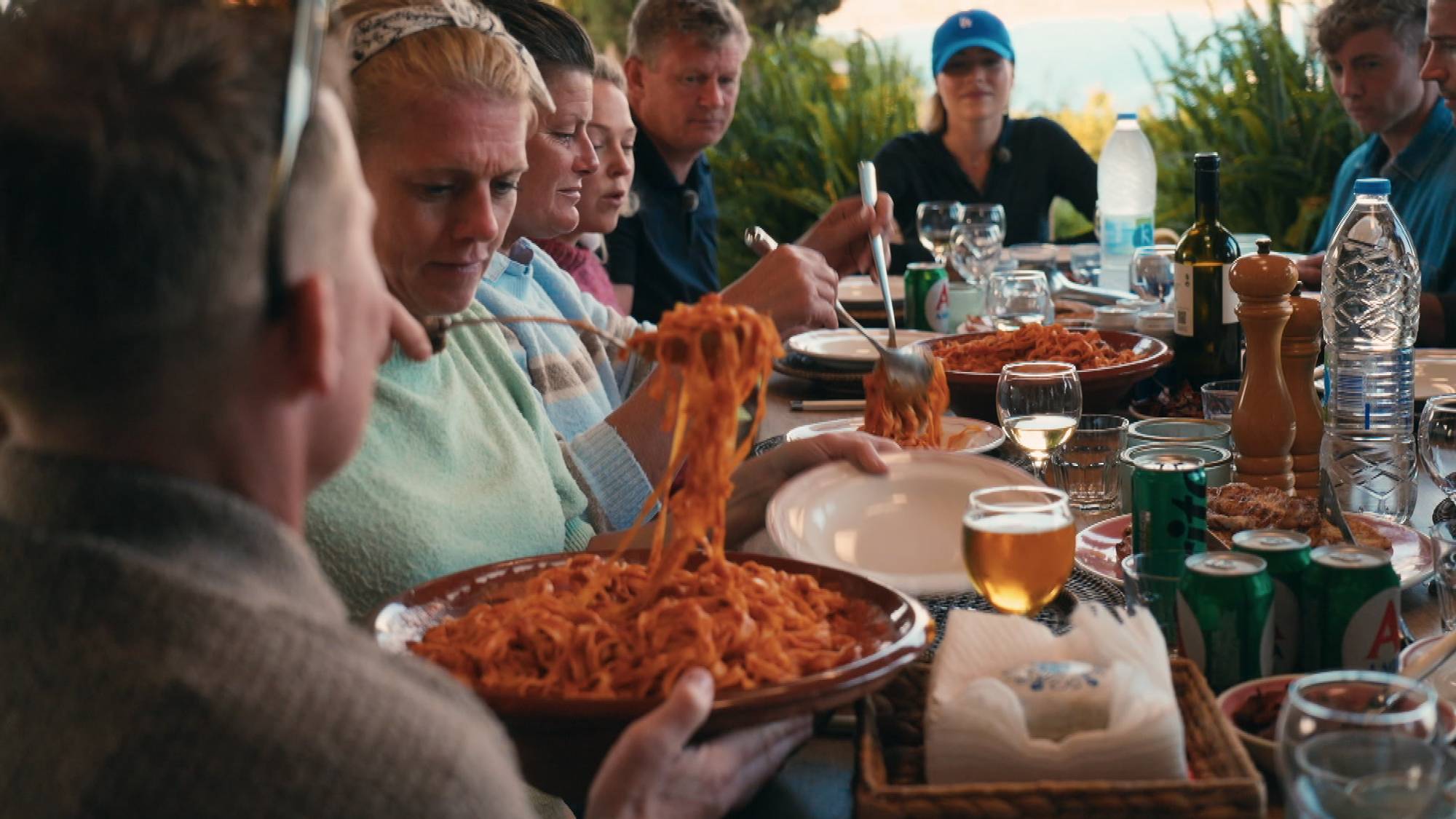 diverse bilder fra et kjøkken i Hellas der deltakere i Mesternes mester tema lager middag. Det er pasta med en rød saus og kylling og bacon. 