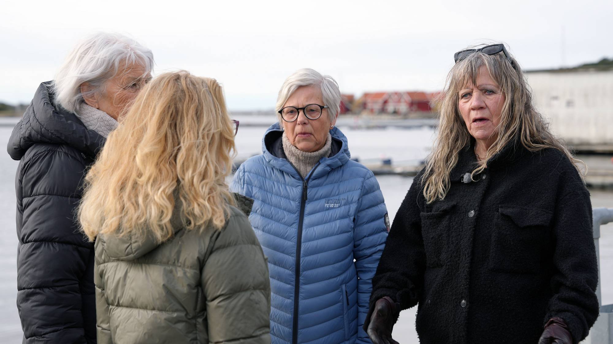 Kvinner står og snakker sammen ved en brygge på Hvaler. 
