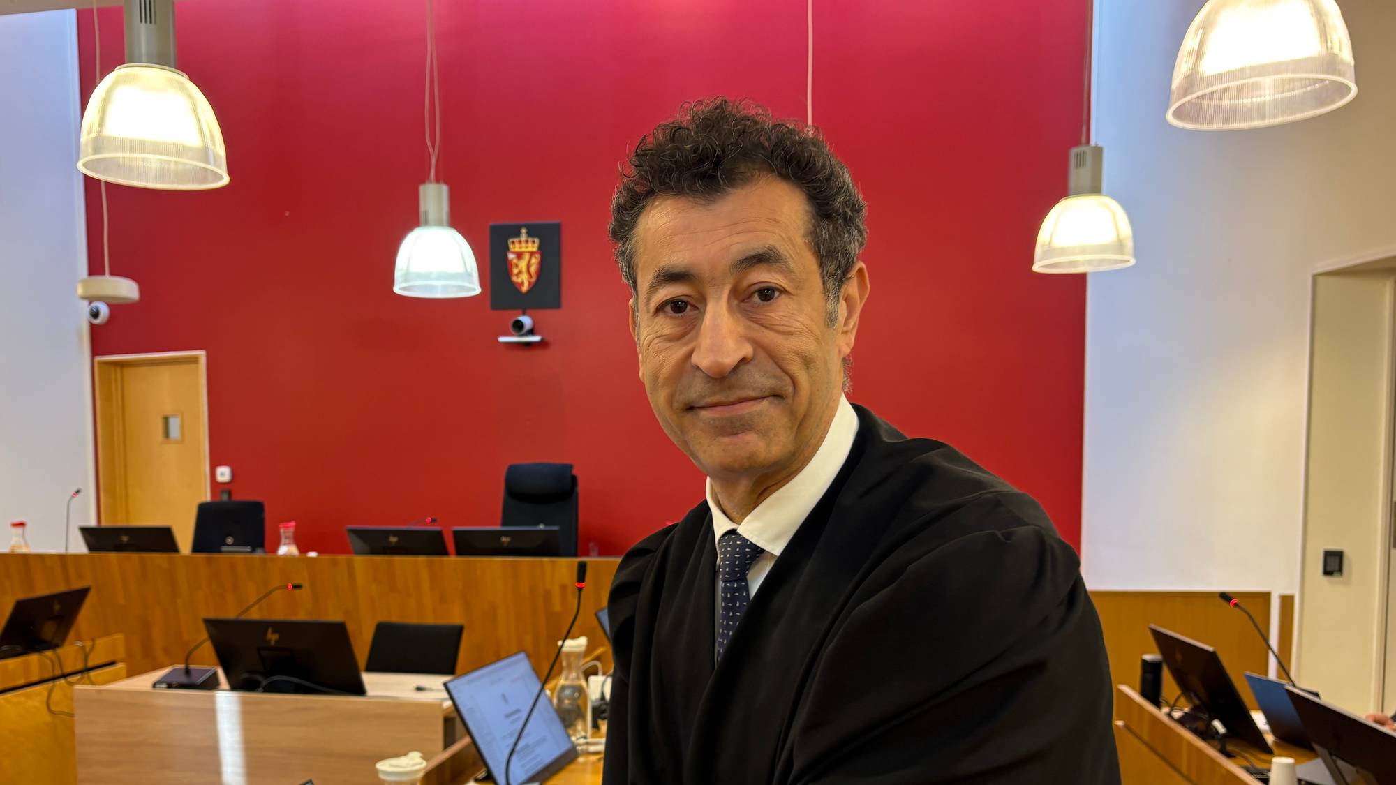 Advokat Abdelilah Saeme står ved en skrivepult i en rettssal i Ski