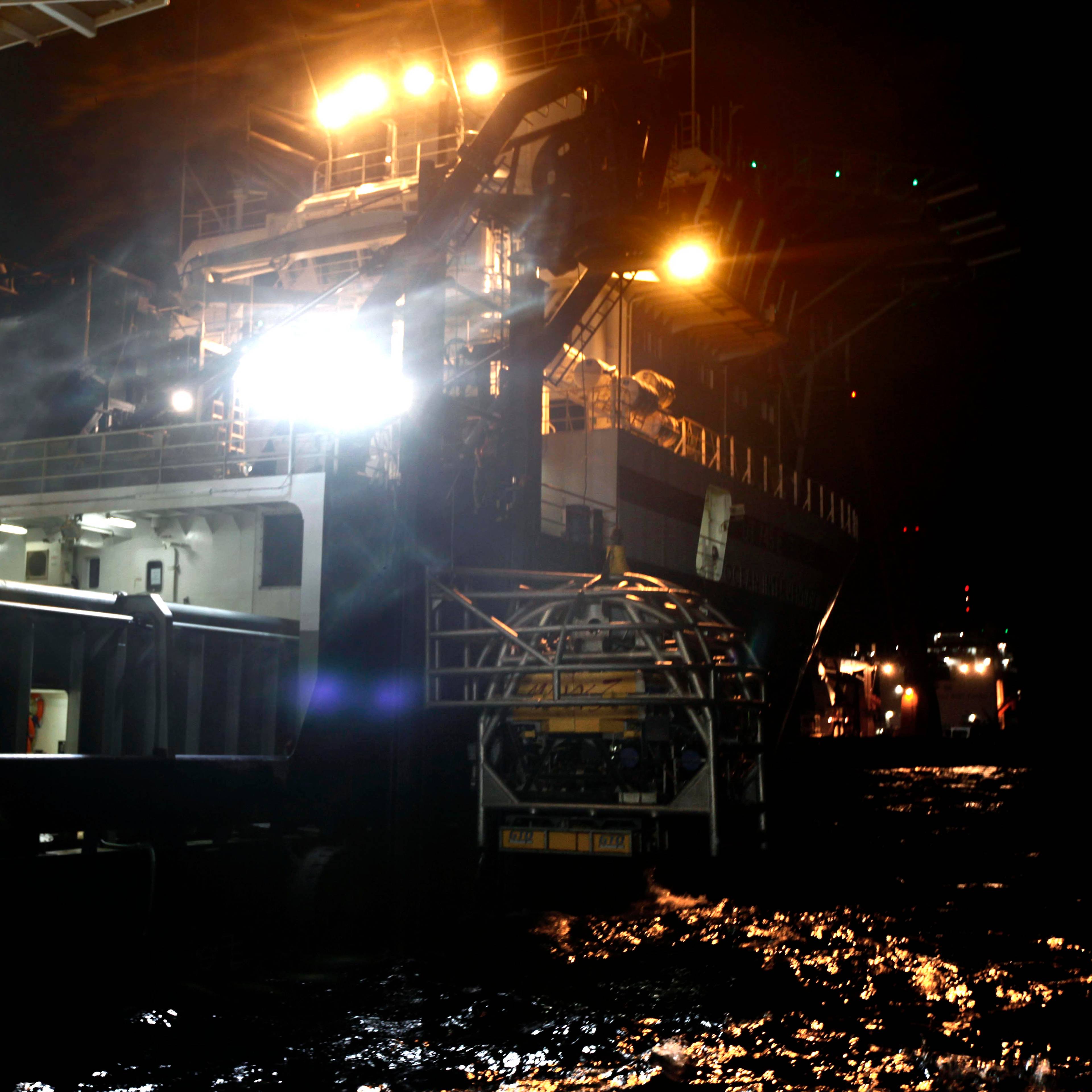 A remote operated vehicle is lowered from the Ocean Intervention III to assist in the Deepwater Horizon oil spill containment efforts in the Gulf of Mexico, off the coast of Louisiana Saturday, May 8, 2010. (AP Photo/Gerald Herbert)