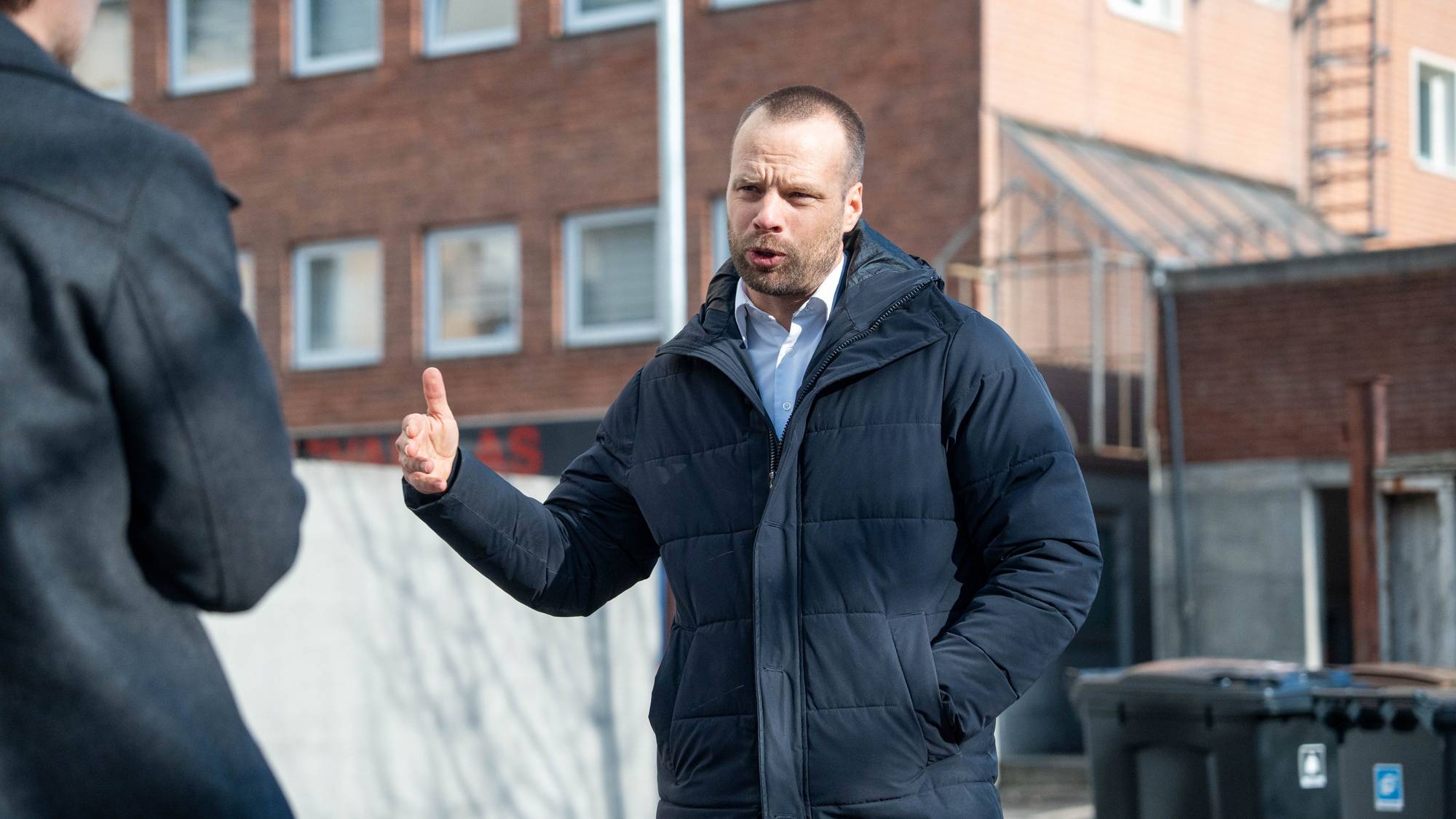 Man står foran mursteinsbygning
