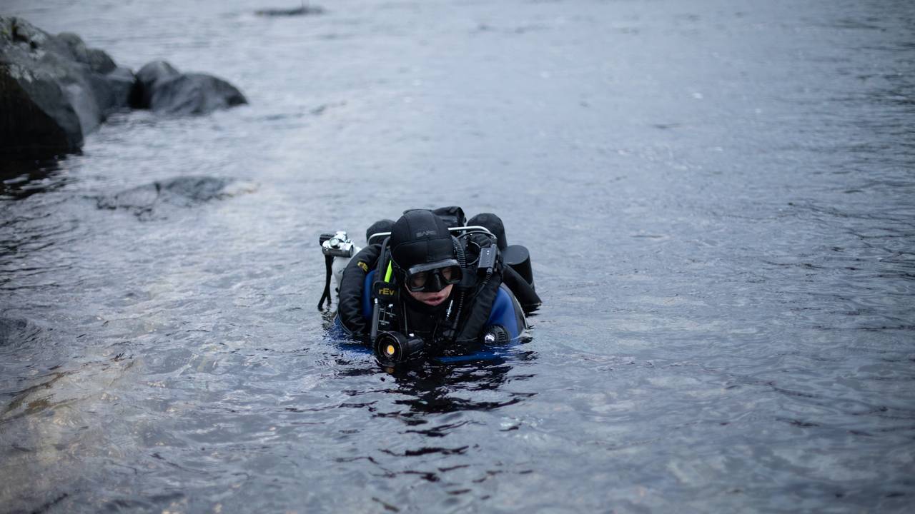 Espen Rekdal har hodet over vann og er på vei til å dykke ved Fosnastraumen