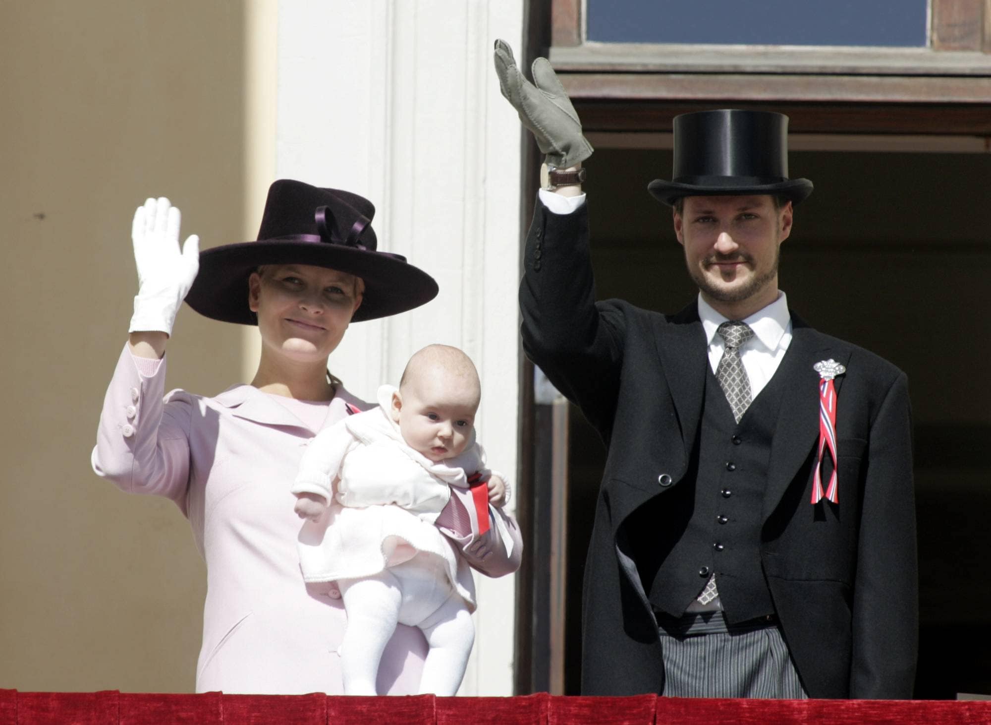 Kronprins Haakon og kronprinsesse Mette-Marit med fire måneder gamle prinsesse Ingrid Alexandra på armen på Slottsbalkongen på 17. mai 2004