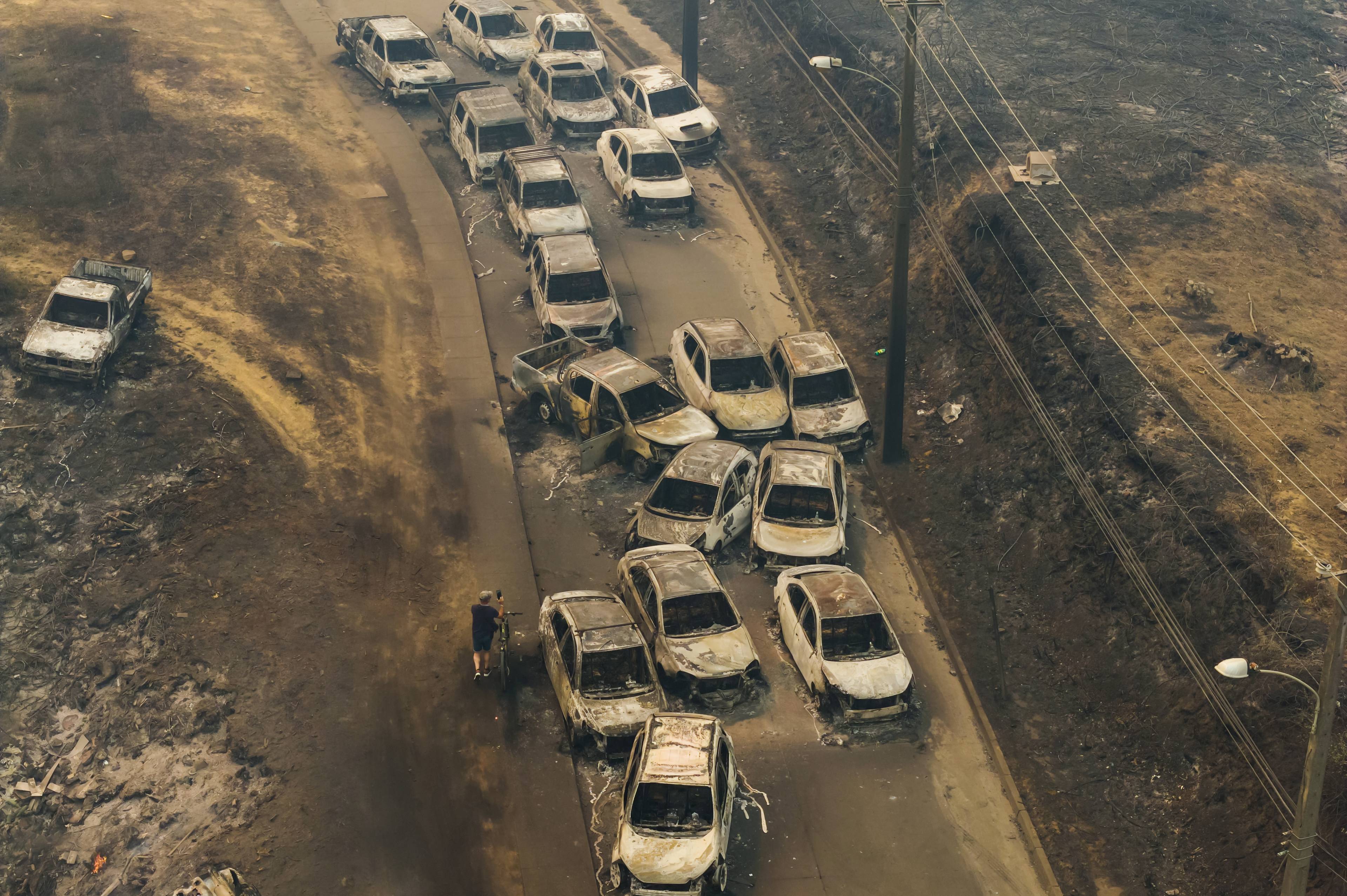 Utbrente biler etter at skogbranner har rasert boligområder i Lirquen i Chile søndag.