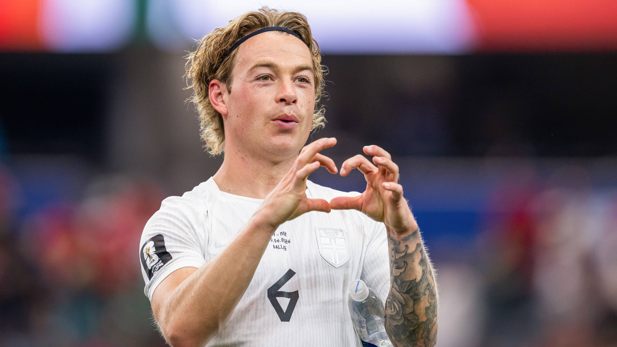 Fotballspiller holder opp hjerte