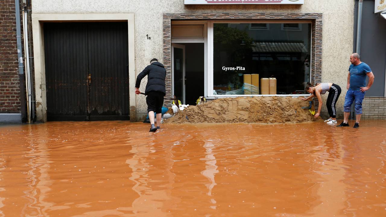 Gatene er blitt til elver og butikkeierne forsøker å redde arbeidsplassene sine.