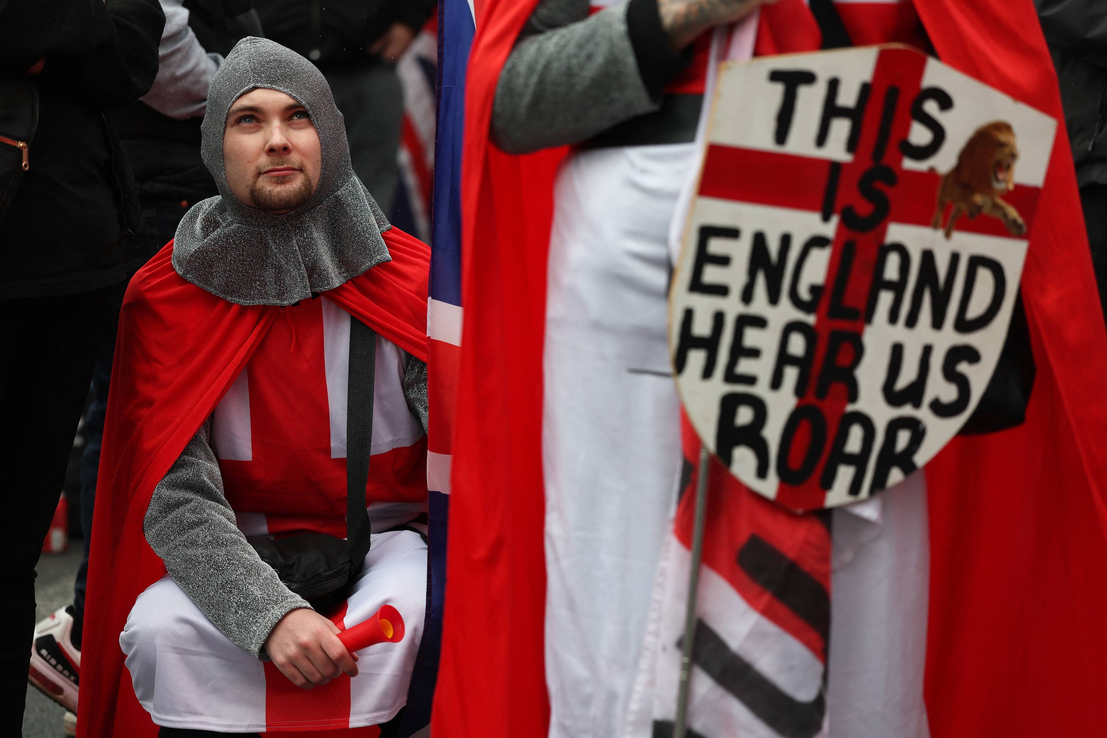 En aktivist i ridderkostyme deltar i "Unite the Kingdom"-toget.