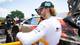 TGR Gazoo Racing / NTB Rallykjører med caps og hvit drakt står ved siden av en bil i et depotområde. (Bildebeskrivelsen er laget av en KI-tjeneste)