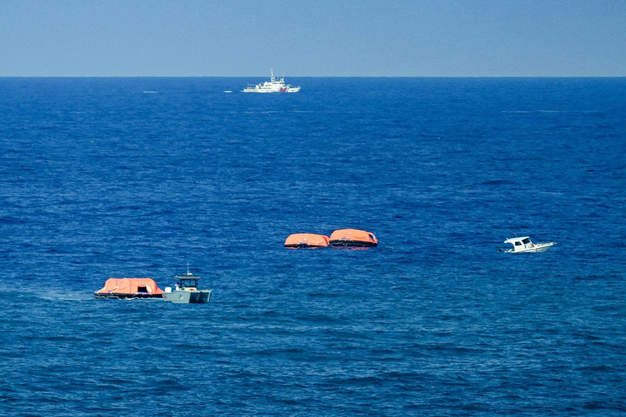 Turkish vessels and rescue rafts are pictured off the port of Kyrenia in the self-proclaimed Turkish Republic of Northern Cyprus (TRNC), recognised only by Turkey, in the north of the divided Mediterranean island of Cyprus on August 30, 2026 during search and rescue operations following a ferry capsizing. At least six people died when a ferry capsized off Northern Cyprus on August 30, the head of the local government said, in a preliminary toll to Turkish media. The vessel had been carrying a total of 267 people when it rolled over shortly after leaving port, according to Turkish state news agency Anadolu. (Photo by Jewel SAMAD / AFP)