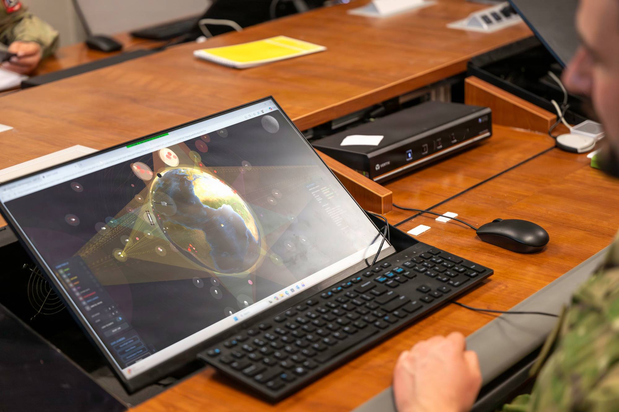 A coalition space professional monitors data during the Space Tactics Analysis Team working group