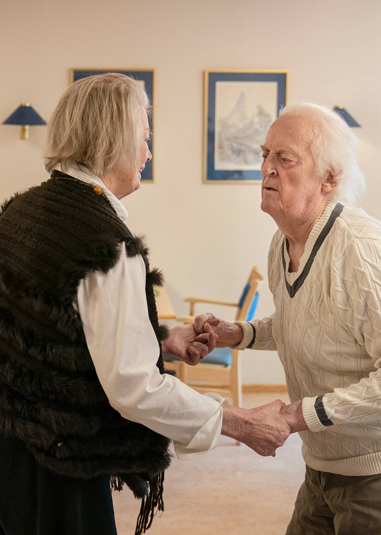 Ekteparet danser sammen i oppholdsrommet