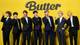 Lee Jin-man / AP,NTB Syv personer står tett sammen foran en gul bakgrunn med teksten "Butter" i svart. De er kledd i formelle dresser og stiller ulike poseringer, noen med hender opp og andre med hender til munnen. Arrangementet ser ut til å være et offentlig fremmøte knyttet til en musikkutgivelse. Omgivelsene er enkle og fokuserer på personene i bildet. (Bildebeskrivelsen er laget av en KI-tjeneste)