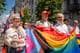 Dan Bashakov / AP,NTB Personer holder et Pride-flagg i en gateparade.