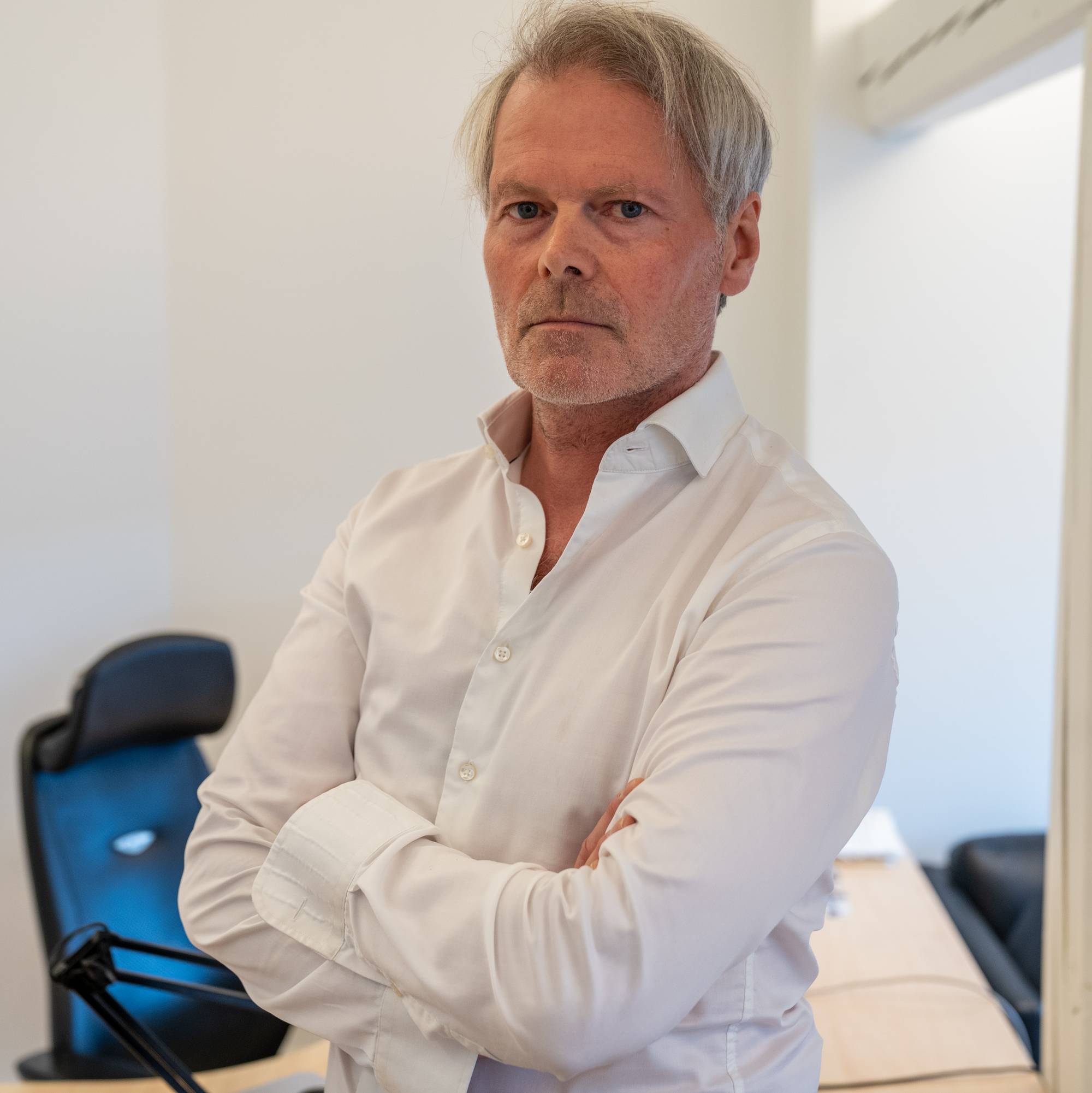 Mann i hvit skjorte på kontor.