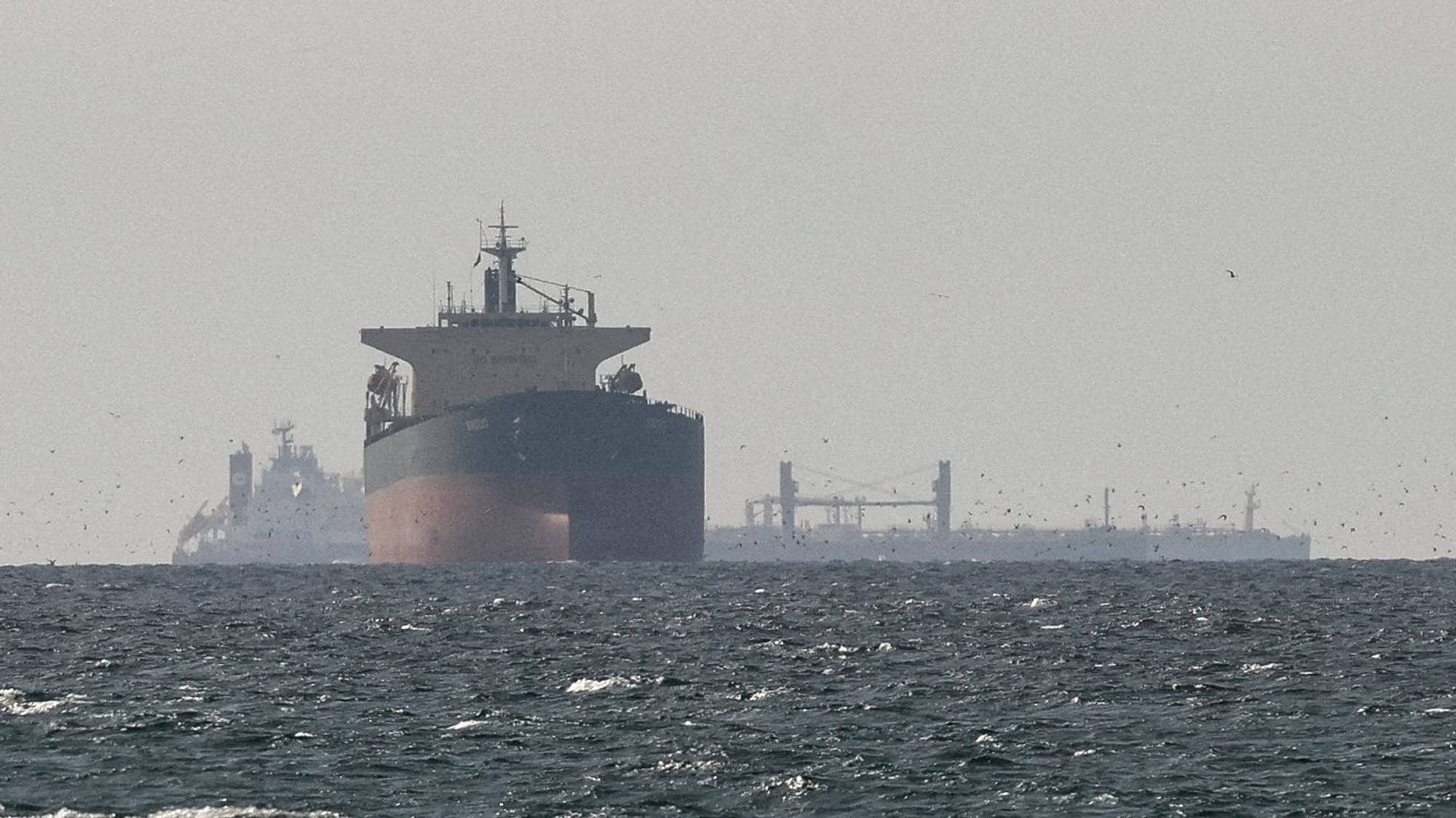 FILE PHOTO: Cargo ships in the Gulf, near the Strait of Hormuz, as seen from northern Ras al-Khaimah, near the border with Oman’s Musandam governance, amid the U.S.-Israeli conflict with Iran, in United Arab Emirates, March 11, 2026. REUTERS/Stringer//File Photo REFILE - CORRECTING "TANKERS" TO "CARGO SHIPS" AND REMOVING ACTION "SAIL".
