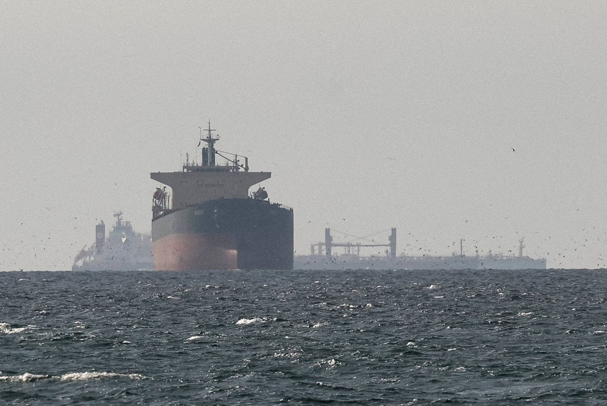 FILE PHOTO: Cargo ships in the Gulf, near the Strait of Hormuz, as seen from northern Ras al-Khaimah, near the border with Oman’s Musandam governance, amid the U.S.-Israeli conflict with Iran, in United Arab Emirates, March 11, 2026. REUTERS/Stringer//File Photo REFILE - CORRECTING "TANKERS" TO "CARGO SHIPS" AND REMOVING ACTION "SAIL".