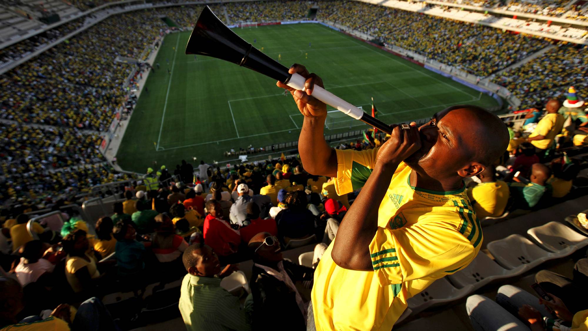 A fan blows a vuvuzela during an international friendly soccer match between Thailand and South Africa in preparation for the 2010 World Cup at Mbombela stadium in Nelspruit May 16, 2010. Picture taken May 16, 2010. REUTERS/Siphiwe Sibeko (SOUTH AFRICA - Tags: SPORT SOCCER WORLD CUP)