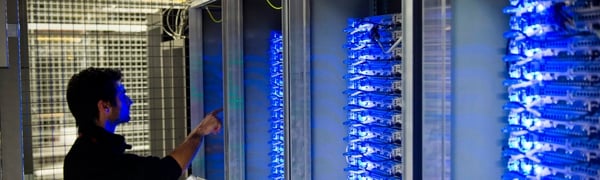 (FILES) This file photo taken on July 21, 2014 shows an employee of Equinix data center checking servers on July 21, 2014 in Pantin, a suburb north of Paris in the Seine-Saint-Denis department.  The world's biggest ransomware attack levelled off in Europe on May 15, 2017 hanks to a pushback by cyber security officials after causing havoc in 150 countries, as Microsoft urged governments to heed the "wake-up call". / AFP PHOTO / MARTIN BUREAU