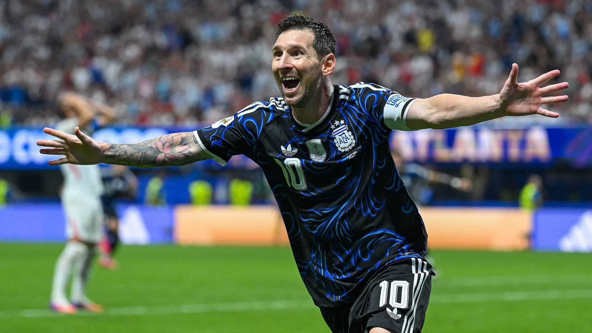 Lionel Messi jubler i Argentina-drakt på en fotballbane med publikum i bakgrunnen. (Bildebeskrivelsen er laget av en KI-tjeneste)