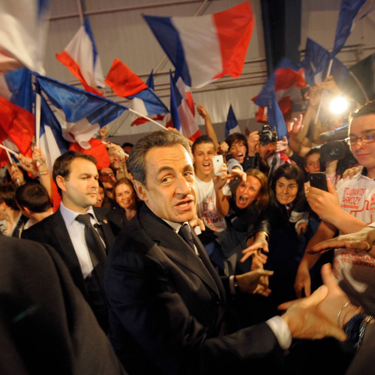 France's President and UMP party candidate for his re-election in the 2012 French presidential elections, Nicolas Sarkozy, shakes hands with supporters as he arrives to attend a campaign rally in Toulouse