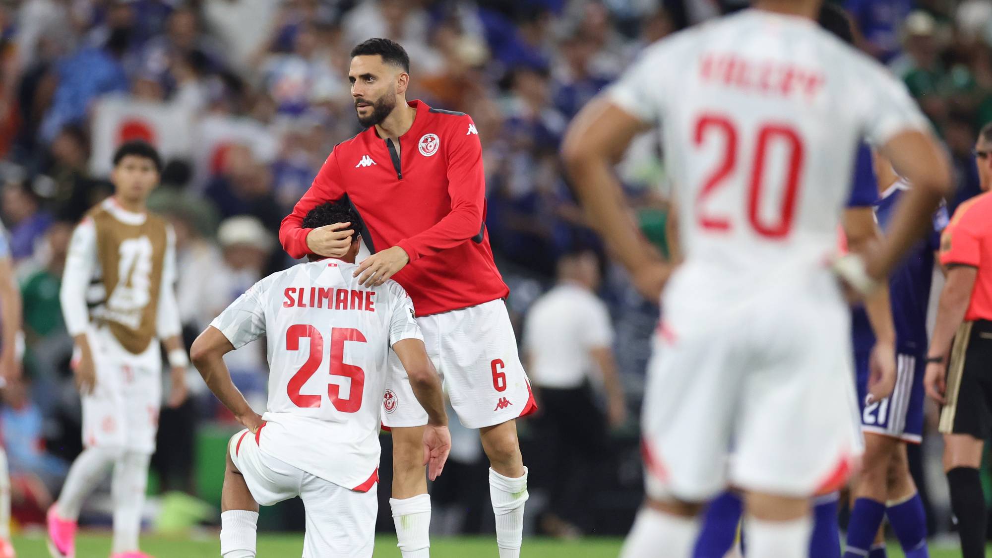 Tunisia's Dylan Bronn (6) consoles teammate Anis Slimane (25) 