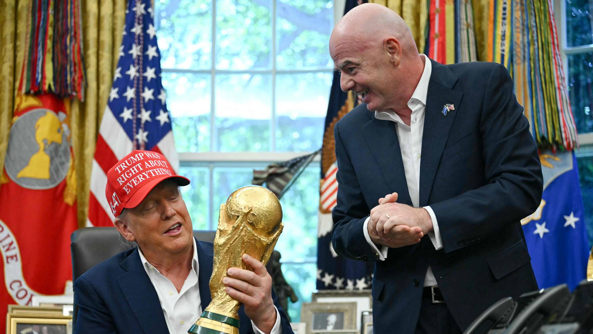 Donald Trump viser frem VM-pokalen til FIFA-president Gianni Infantino i Det ovale kontor. (Bildebeskrivelsen er laget av en KI-tjeneste)