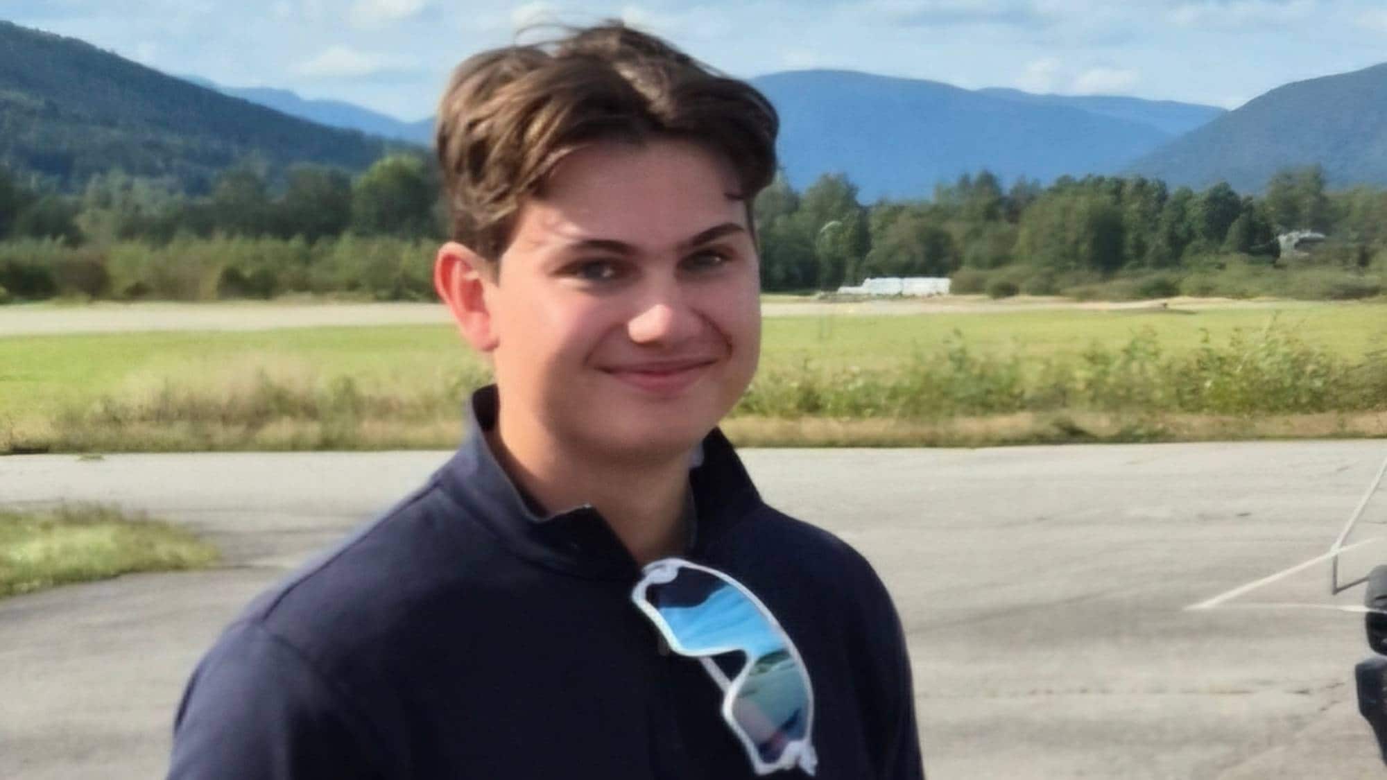 Gutt med mørk overdel og lyse bukser. Brunt hår, smiler og ser inn i kamera.