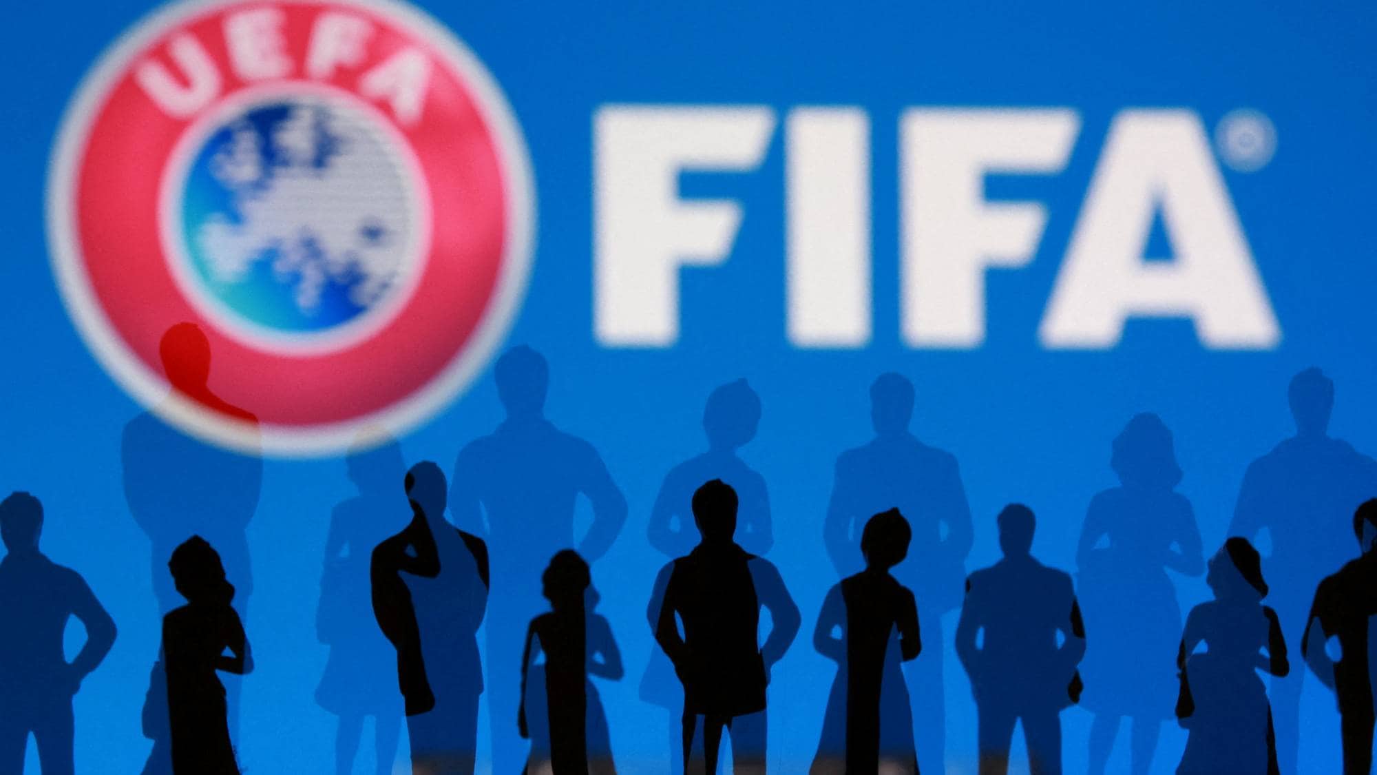 FIFA and UEFA logos and silhouettes of people are seen in this illustration taken July 30, 2026. REUTERS/Dado Ruvic/Illustration