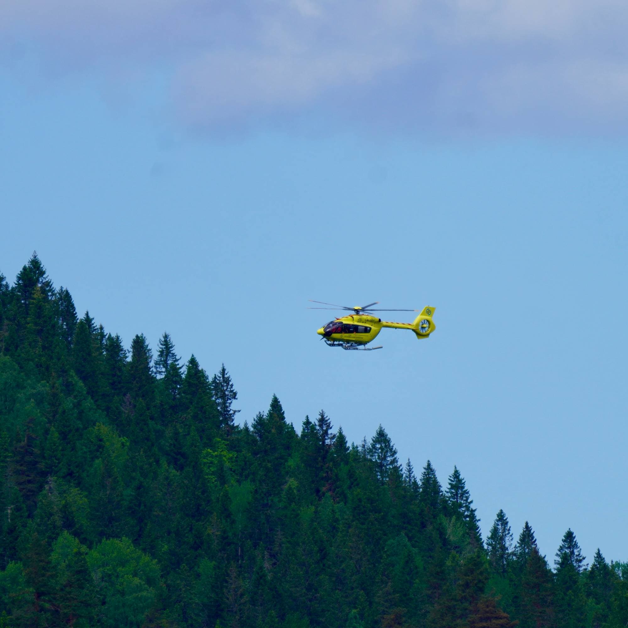 Ambulansehelikopter over skogkam