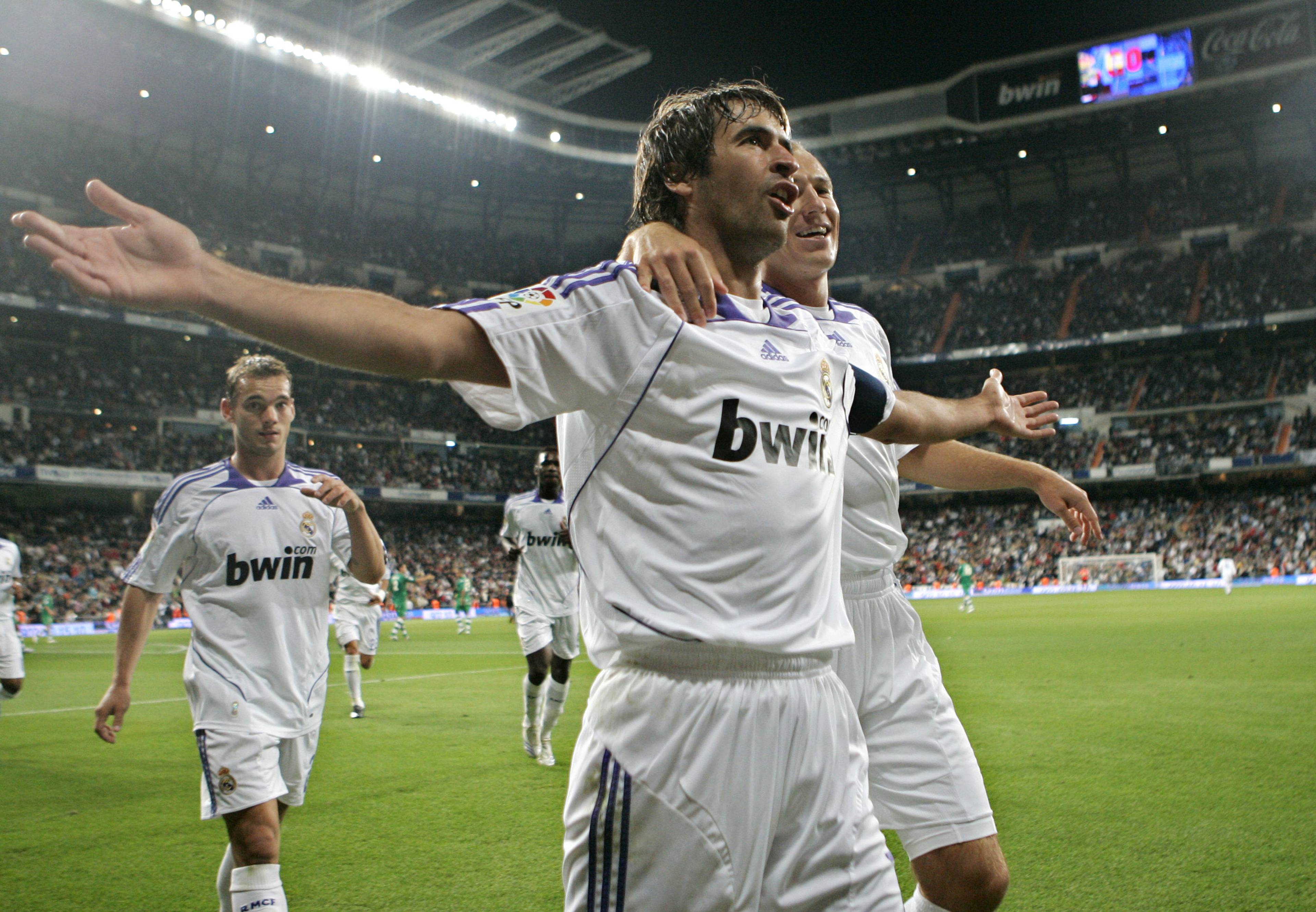 Real Madrid's captain Raul Gonzalez celebrates with teammates Arjen Robben, right, and Wesley Sneijder, left after Raul scored against Betis during a Spanish league soccer match at the Bernabeu stadium in Madrid, Thursday Sept. 27, 2007.  (AP Photo/Paul White)