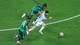 Siphiwe Sibeko / REUTERS,NTB Tre fotballspillere er i luften under en kamp. En spiller i hvit drakt med blå striper, antatt å være Lionel Messi, hopper mens to spillere i grønn drakt prøver å hindre ham. En fotball ligger på gresset til høyre i bildet. Bildet er tatt fra et fugleperspektiv. (Bildebeskrivelsen er laget av en KI-tjeneste)