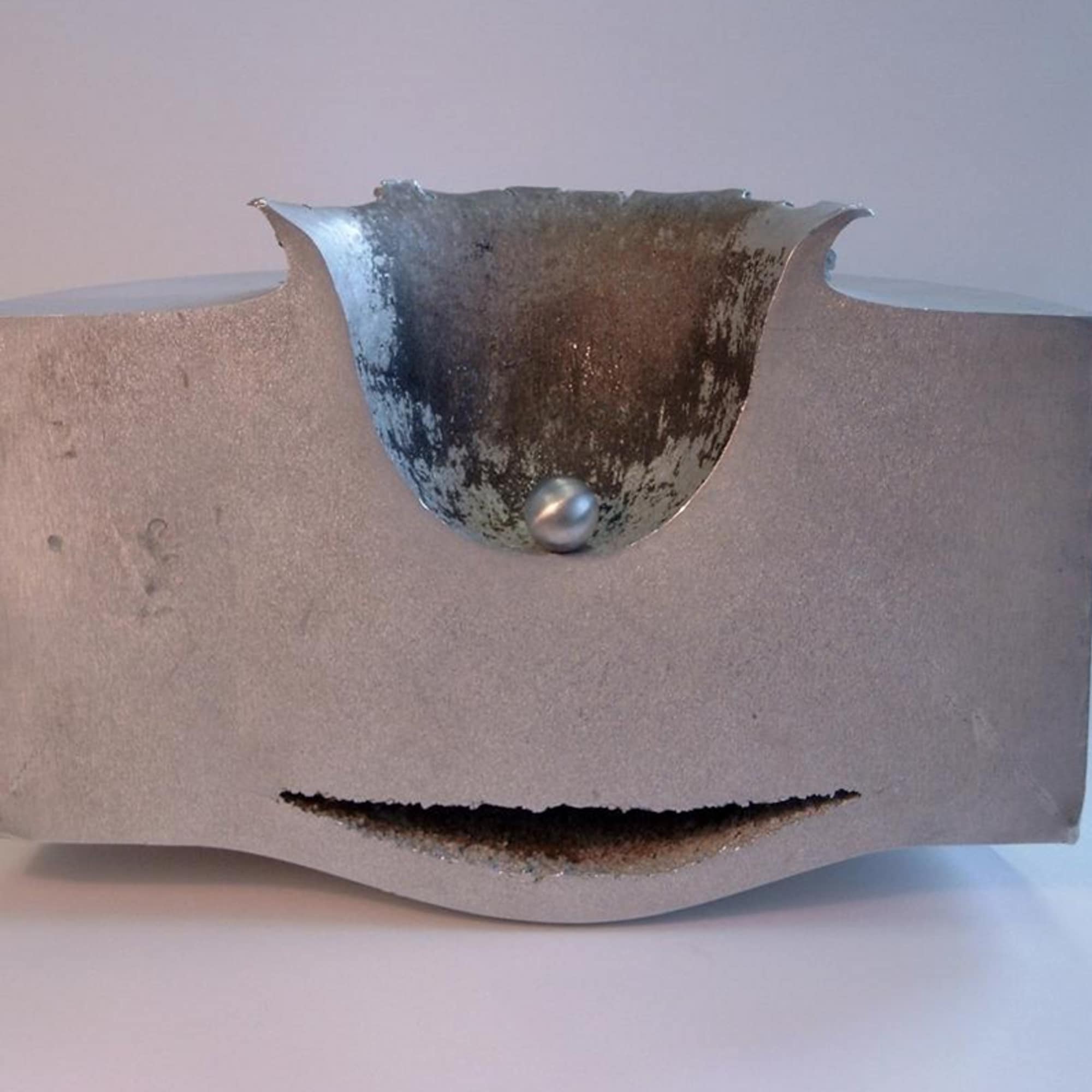 This image shows the results of a lab test impact between a small sphere of aluminum travelling at approximately 6.8 km/second and a block of aluminum 18 cm thick. This test simulates what can happen when a small space debris object hits a spacecraft.