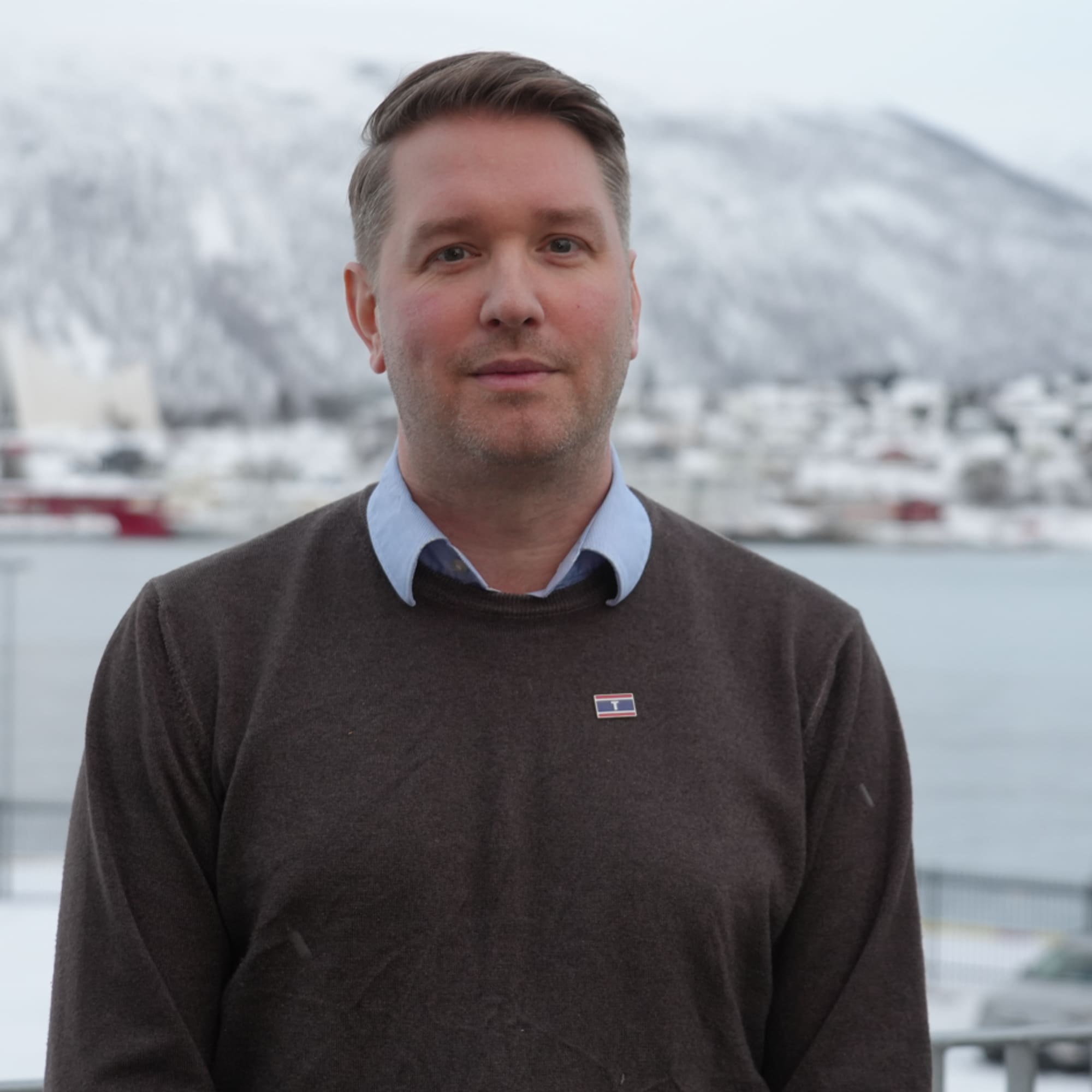 Marius Hansen outdoors with a snowy fjord in the background