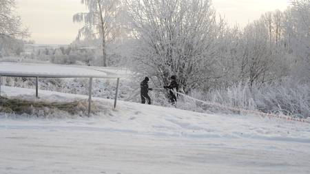Forensic investigators work ​at ⁢the⁣ scene of the attack.