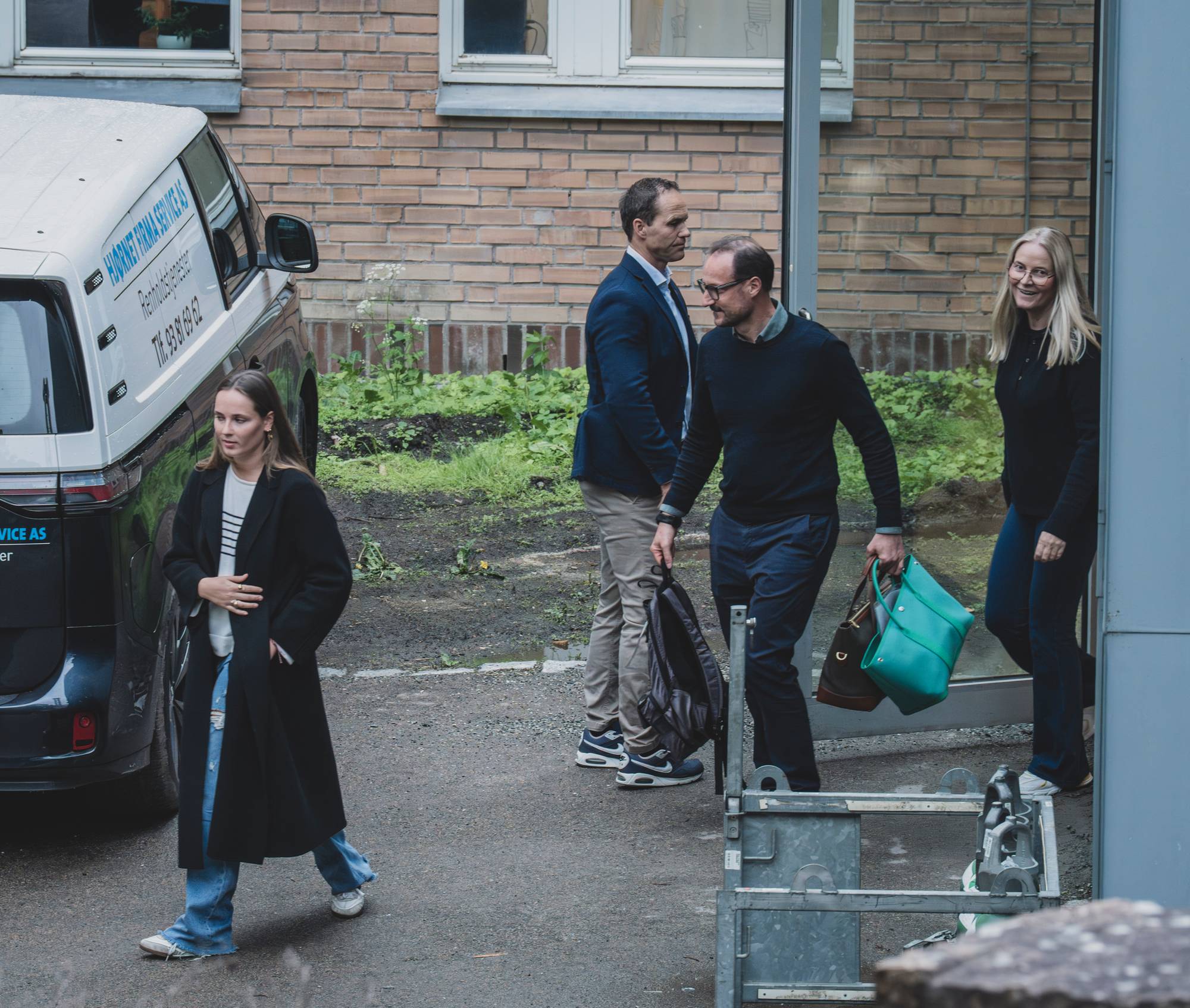 Kronprinsesse Mette-Marit, prinsesse Ingrid Alexandra og kronprins Haakon går ut av en sykehusdør