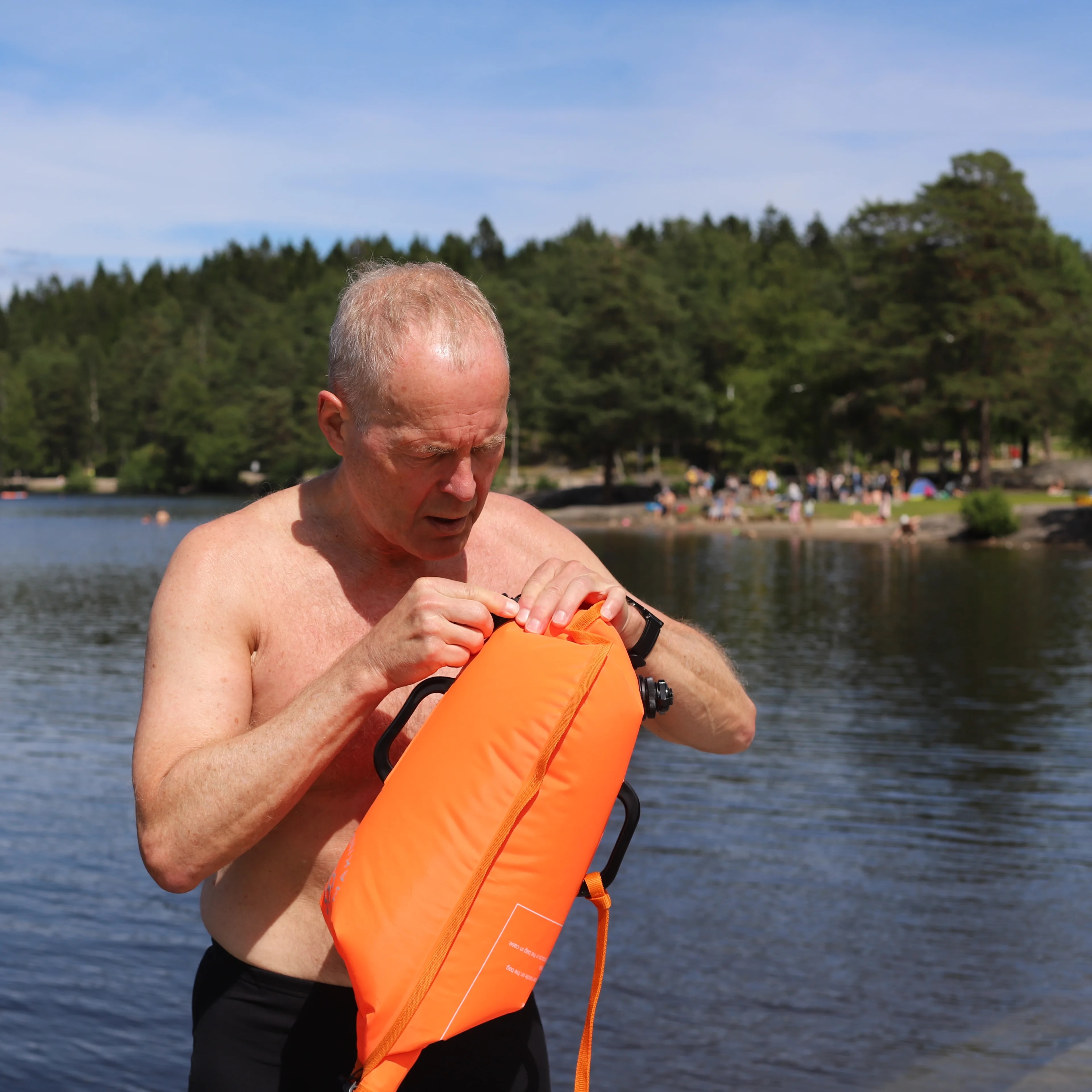 en mann som holder en fisk (Bildebeskrivelsen er laget av en KI-tjeneste)